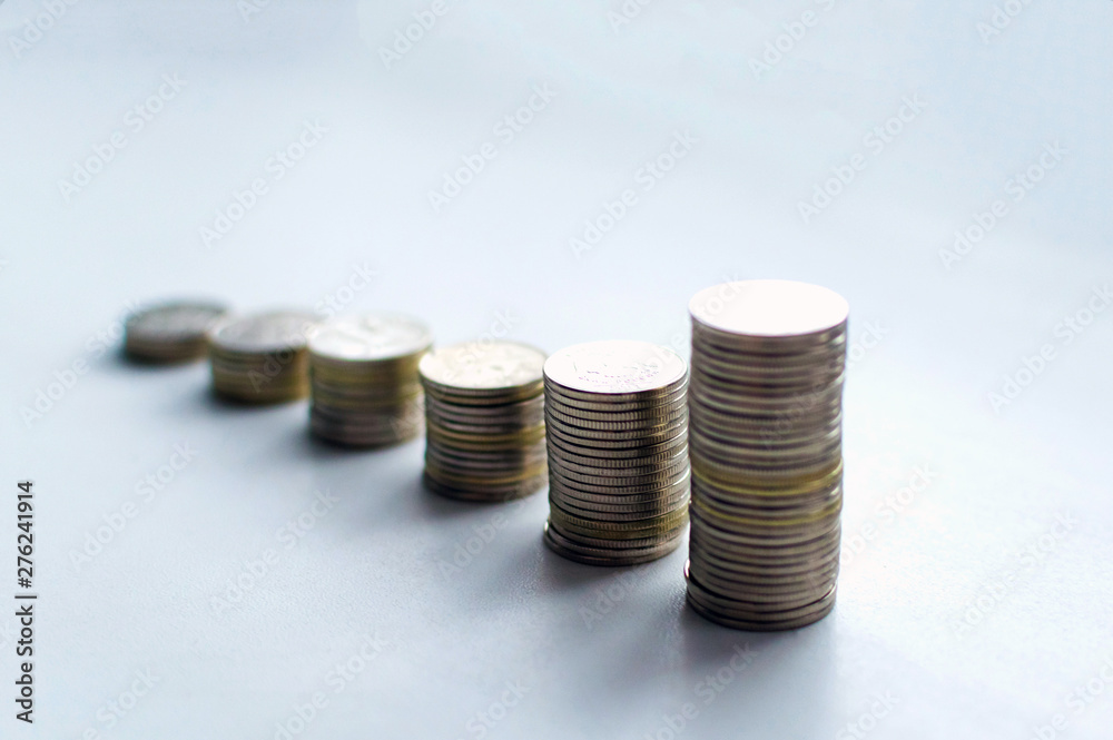 Increasing columns of coins, looks like as growth chart, step of stacks coin isolated on white background with copy space for business and financial concept idea. Increasing columns of coins, looks like as growth chart, step of stacks coin isolated on white background with copy space for business and financial concept idea.