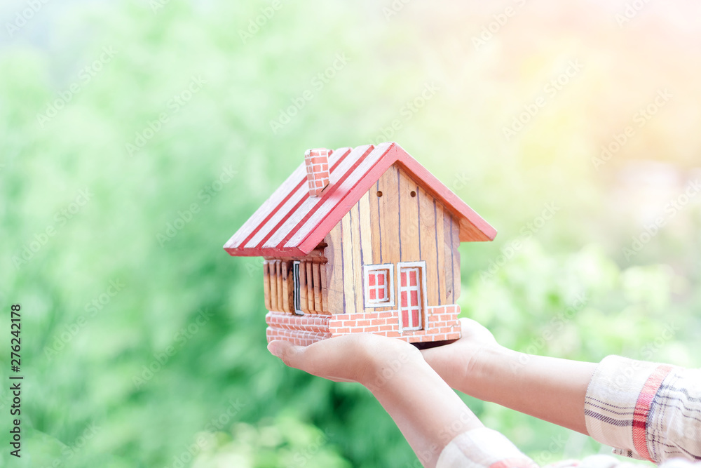 Hands holding house, Real estate investment is a business to build a house to sell to buyers in the market through agents. estate service concept