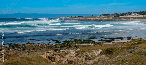 Waves break along the rocky coastal shores of the Monterey Bay, at Asilomar Beach, in Pacific Grove, along the central coast of California, close the the Big Sur coast and Highway 1.