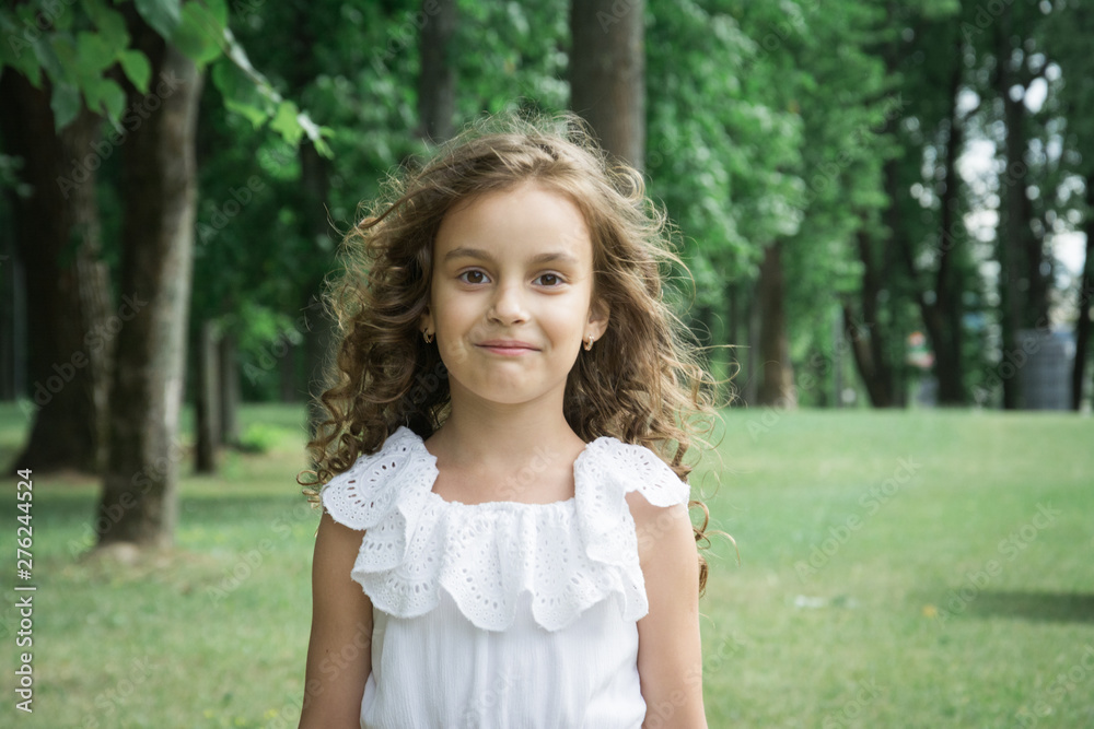 beautiful little girl portrait in summer park