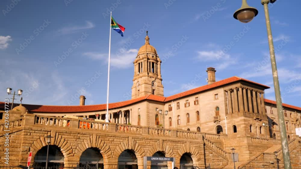South Africa flag blows in the breeze on a flagpole in front of South Africa government building, Union Buildings in Pretoria.