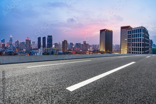 Shanghai skyline panoramic view with asphalt highway at sunset