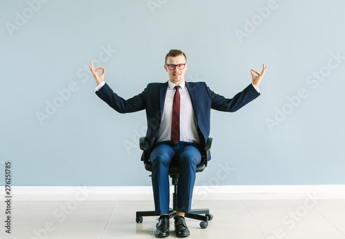 Businessman meditating whil...