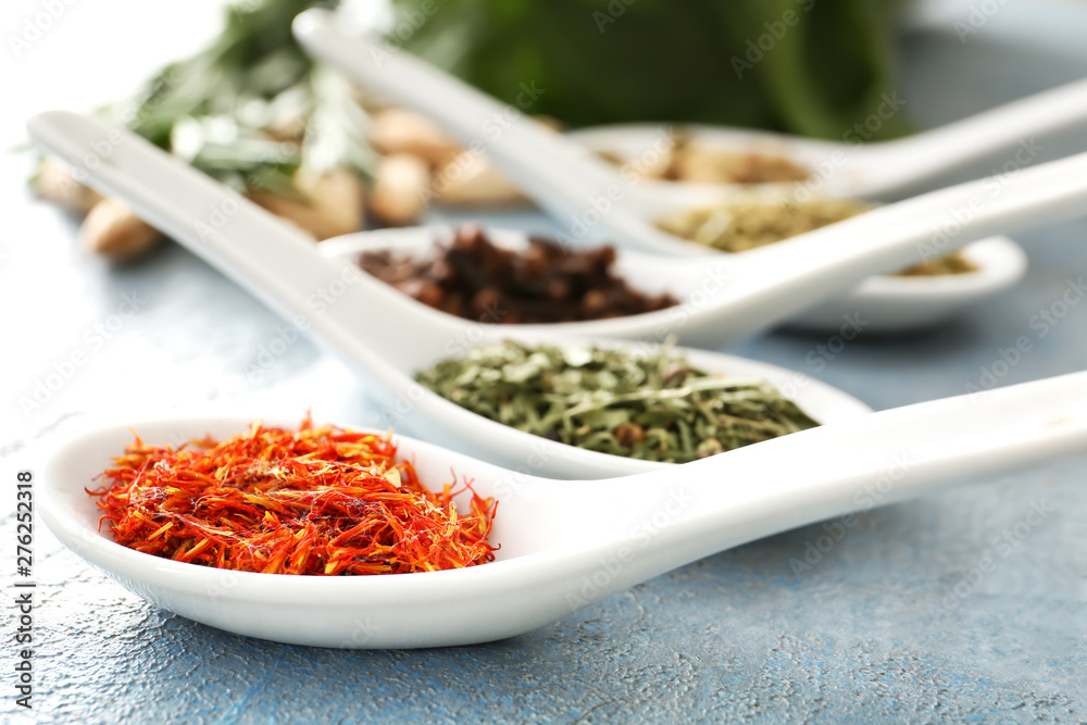 Spoons with different spices on color background Spoons with different spices on color background