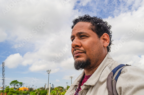 middle-aged man 30-39 years old, using his mobile phone to do self-portrait and using the apps in an outdoor park