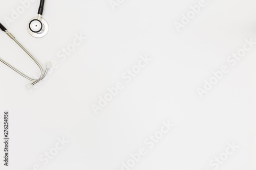Stethoscope  Top view of doctor s desk table  blank paper on white background  above view doctor work tools on white  Stethoscope  laptop  eyeglass and medical drug on white background  
