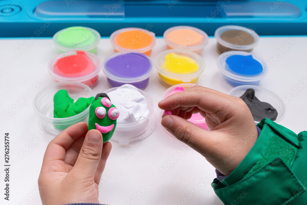kid playing plasticine and modeling something cute kid playing plasticine and modeling something cute