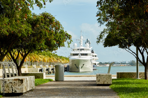 Miami dock with luxury yacht anchored in harbor ready to ship out to ocean in USA