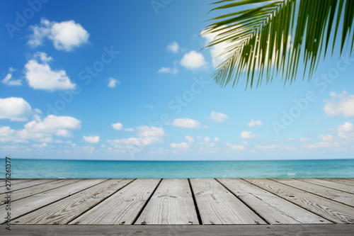 Empty wooden and tropical beach background with palm tree, summer.