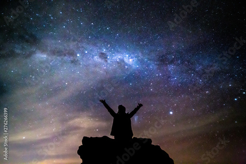 Bild auf Leinwand Person hails the cosmos milky way stars night sky