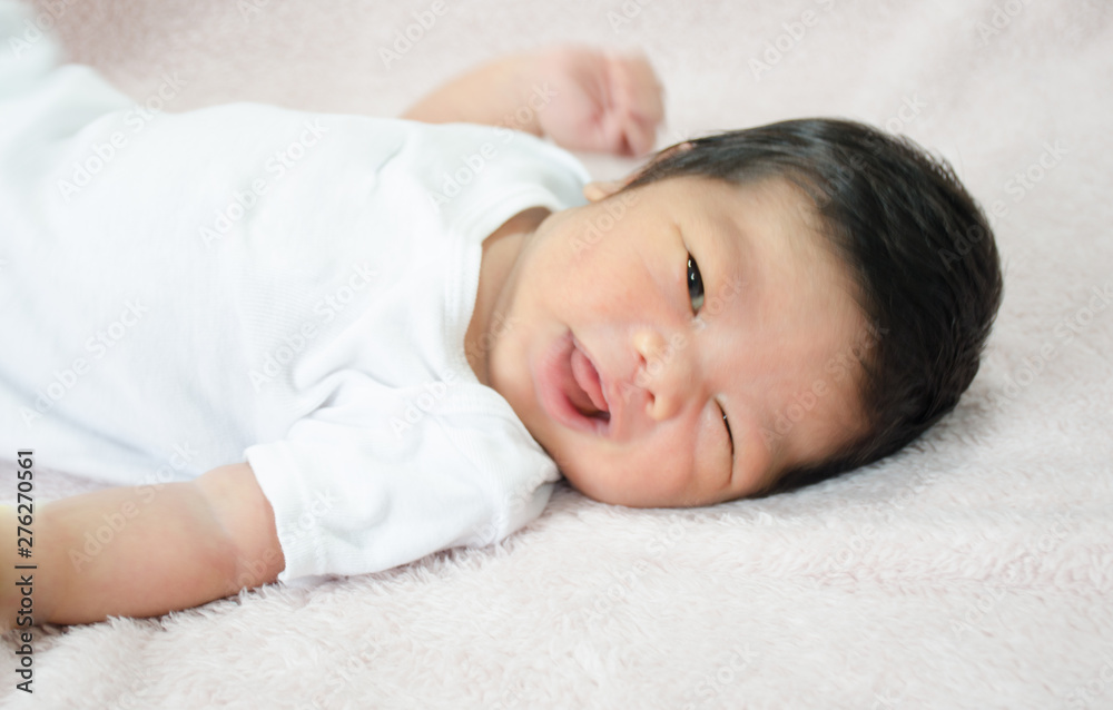 happy baby lying on white sheet happy baby lying on white sheet