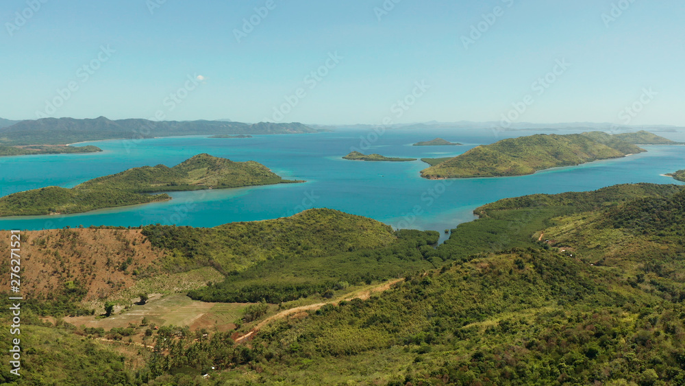 Aerial drone small island group in province of Palawan. Busuanga, Philippines. Seascape, islands covered with forest, sea with blue water. tropical landscape, travel concept