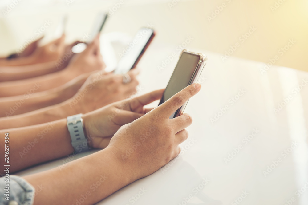 Group of hands people using and looking at mobile phone Group of hands people using and looking at mobile phone