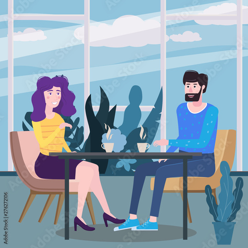 Loving couple is drinking coffee in cafe. A man and a woman in love on date are sitting at a table