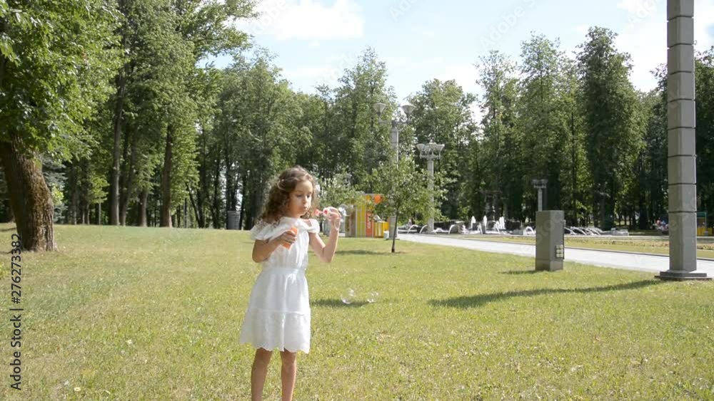 two little children girl and girl playing outdoors and blowing soap bubbles two little children girl and girl playing outdoors and blowing soap bubbles