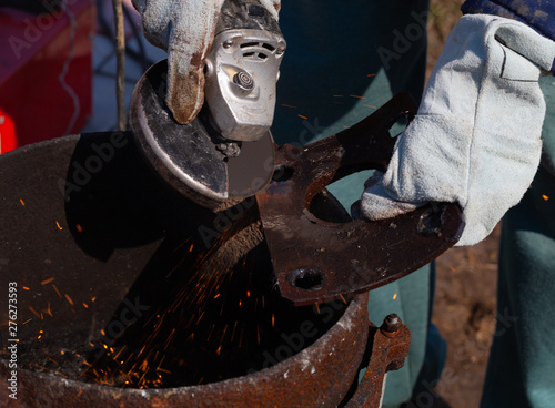 An experienced welder at work. Preparation and welding process of cast iron furnace. Selection focus. Shallow depth of field