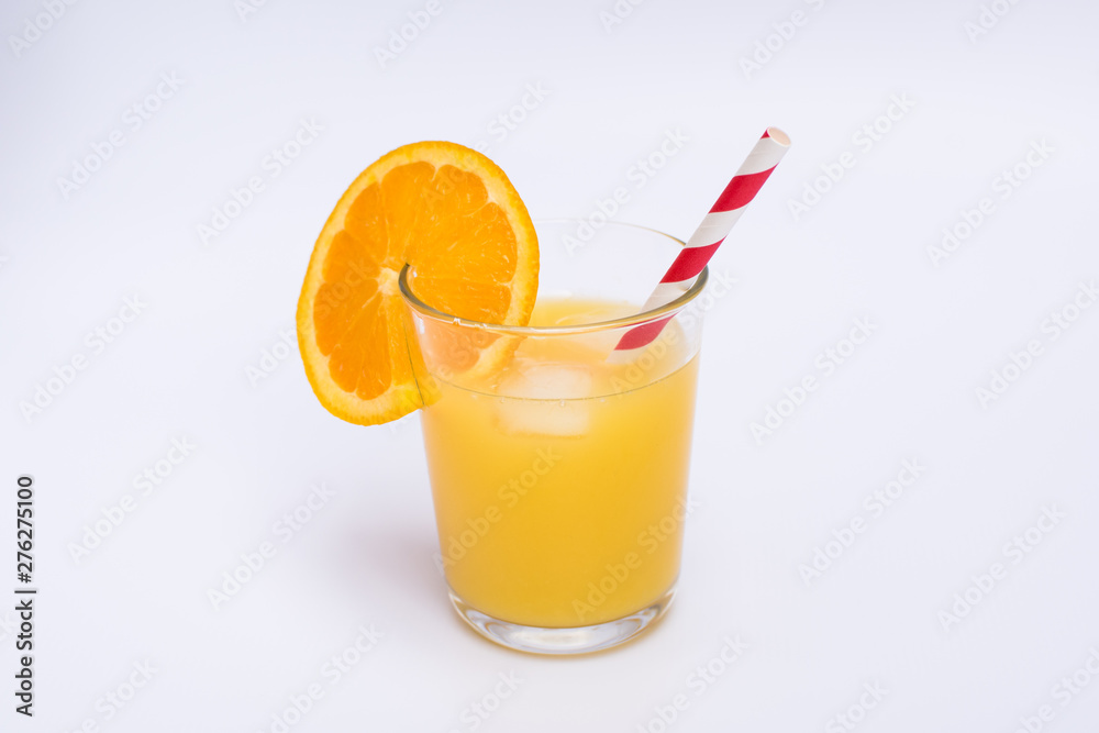 Orange juice in a glass with ice and paper straw on white background Orange juice in a glass with ice and paper straw on white background