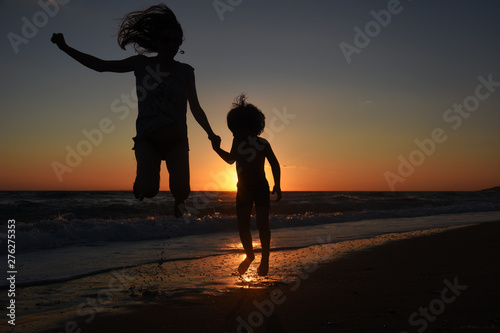 Wallpaper Mural Silhouette of mother and son playing on the beach at the sunset.  Concept of family life and joy, summer vacations Torontodigital.ca