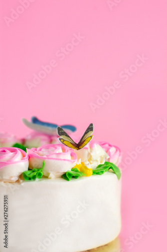 Buttercream frosting of Pink Roses decorated on vanilla pond cake on pink background with copy space served in Birthday Party and wedding. Delicious sweet bakery for someone you love.