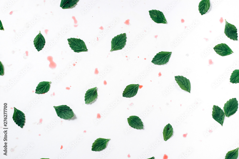 Pattern made green leaves and spots on white background. Flat lay, top view, copy space Pattern made green leaves and spots on white background. Flat lay, top view, copy space
