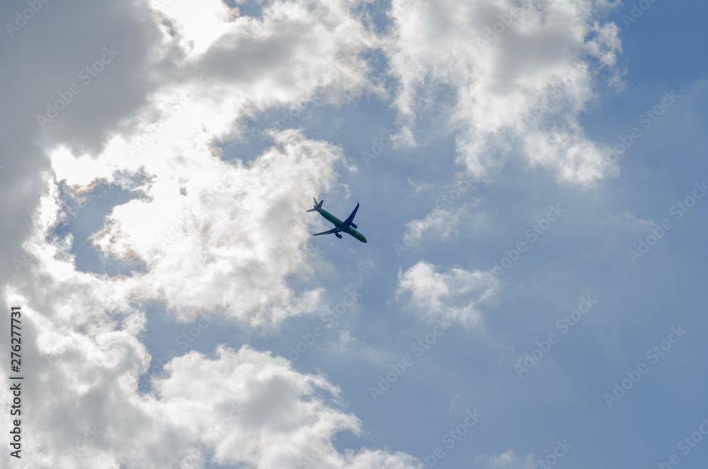 flying airplane in the blue sky with clouds flying airplane in the blue sky with clouds