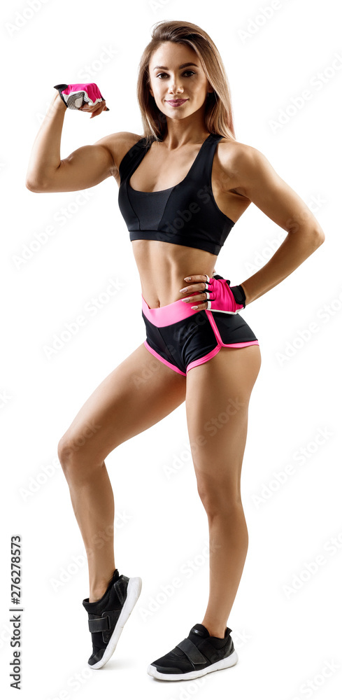 Young woman in sportswear demonstrate her muscular body. Young woman in sportswear demonstrate her muscular body.