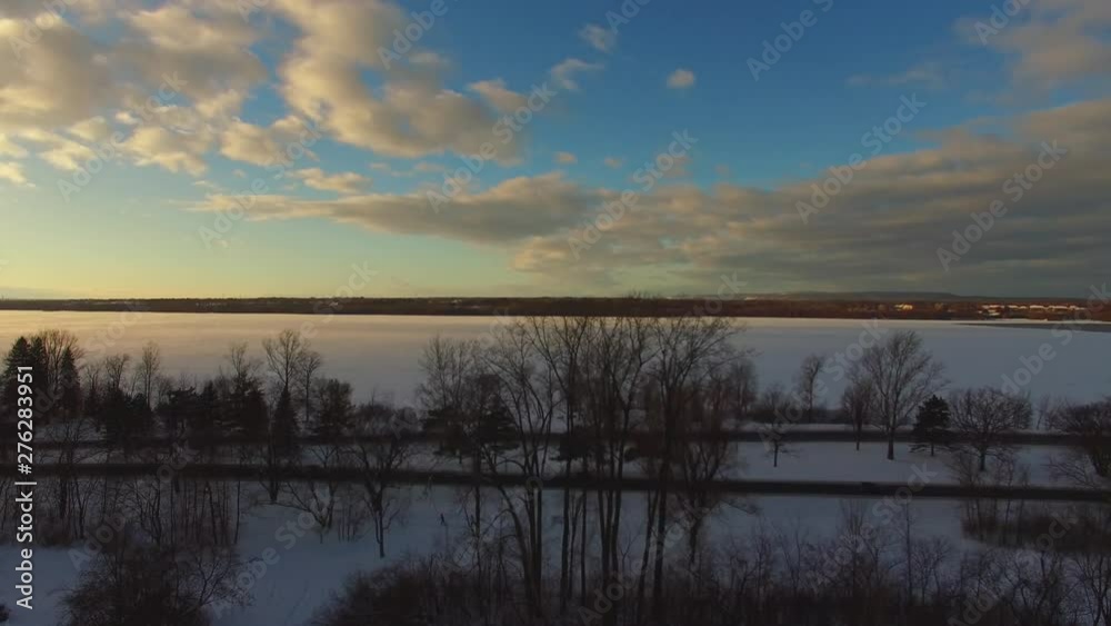 Drone shot of snowy road and beautiful dusk sky. Drone shot of snowy road and beautiful dusk sky.