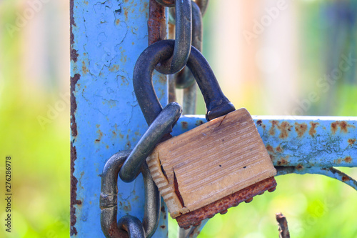 Old padlock on closed doors, Rusty lock at the gate