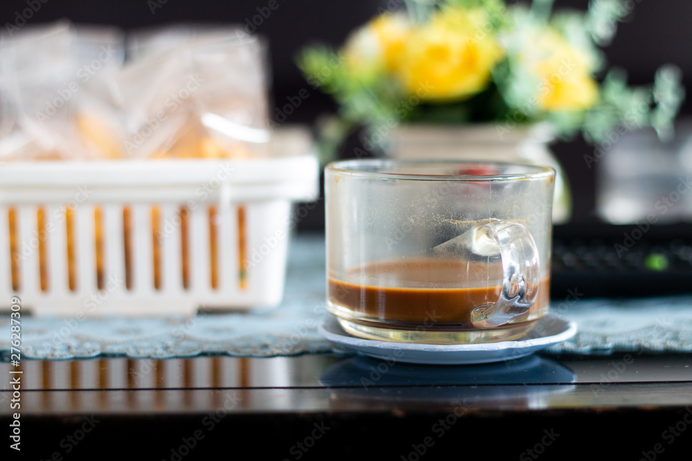 A coffee cup on wooden desk A coffee cup on wooden desk