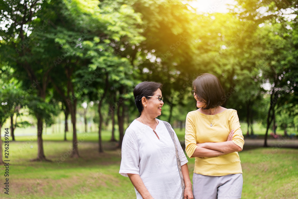 Take care and support concept,Portrait of middle aged asian woman with daughter standing and hugging together outdoor,Happy and smiling,Positive thinking Take care and support concept,Portrait of middle aged asian woman with daughter standing and hugging together outdoor,Happy and smiling,Positive thinking