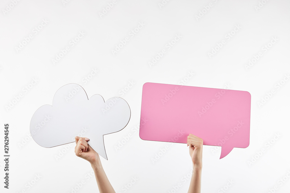 cropped view of woman with pink thought and speech bubbles in hands isolated on white cropped view of woman with pink thought and speech bubbles in hands isolated on white