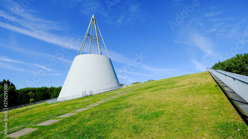 green roof top of sustainable library at delft unversity , white modern architecture on green grass with bule sky background