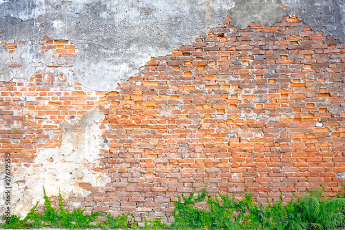 The old building wall that has a slag of cement makes the brick behind.exterior brick walls old buildings decorated with plaster and painted