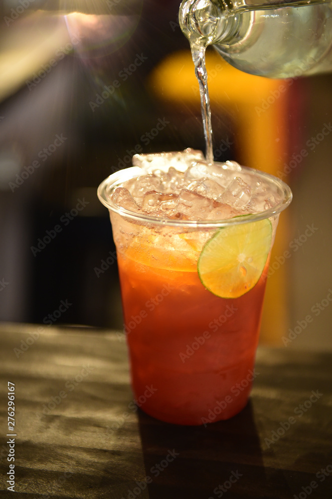 Cold lemon iced tea with fresh sliced lemon in glasses on table Cold lemon iced tea with fresh sliced lemon in glasses on table