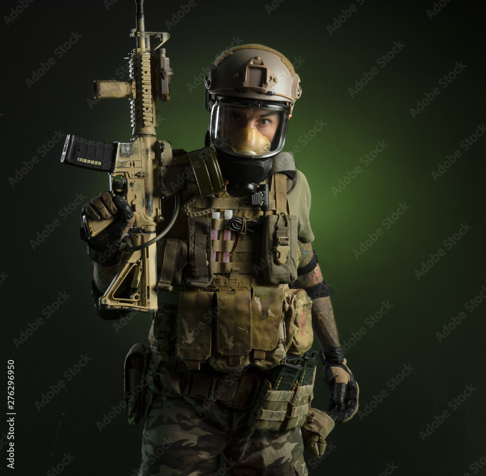 The guy in protective clothing and a black mask with a sniper rifle The guy in protective clothing and a black mask with a sniper rifle