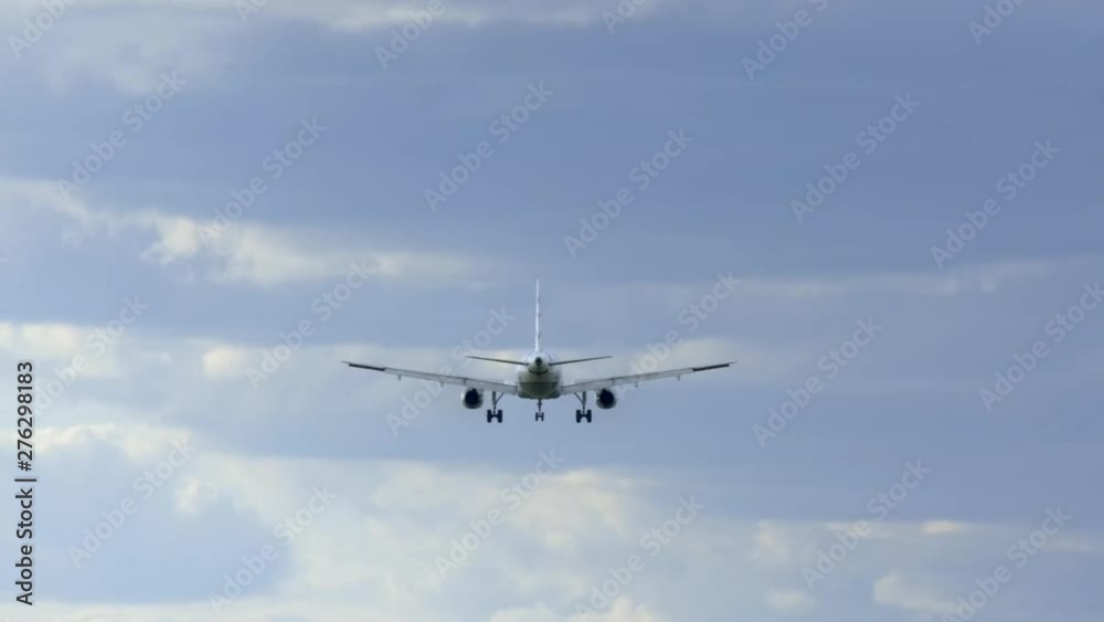 Airplane flies against the background blue sky with clouds. Airplane flies against the background blue sky with clouds.