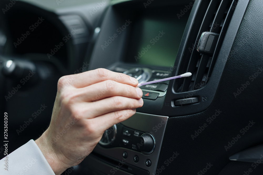Close up of person cleaning car interior