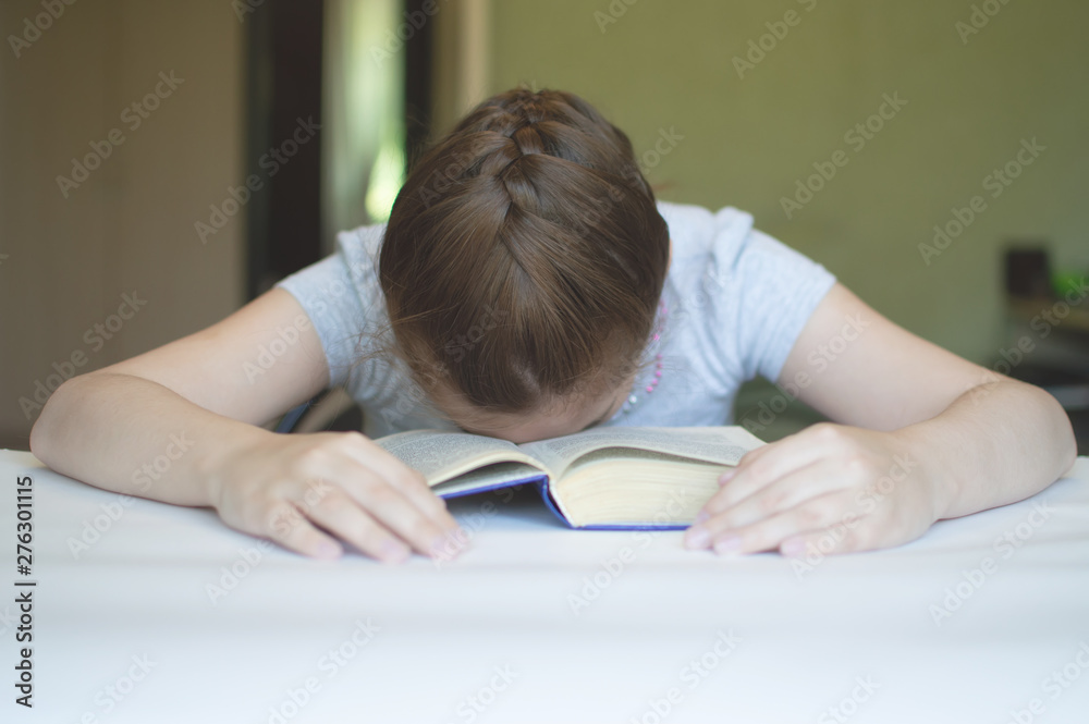 child reading a book at the table child reading a book at the table