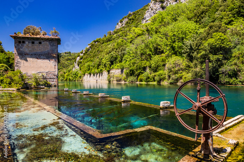 The Roman port of ancient Narnia (Narni), in Stifone, in the canyons of the Nera river. The blue sky and the clear, cold and turquoise water, on a sunny day, in the summer. Wild and pristine nature.