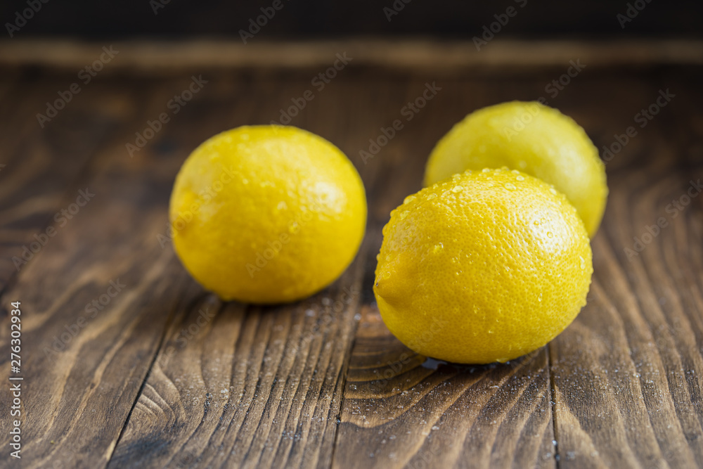 Fresh juicy lemons on the wooden background Fresh juicy lemons on the wooden background