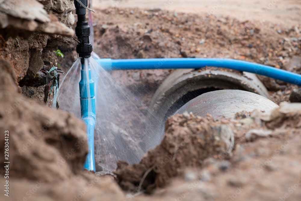 Water pipe break .Exposing a burst water main, focused on the spraying water and the pipe. Water pipe break .Exposing a burst water main, focused on the spraying water and the pipe.