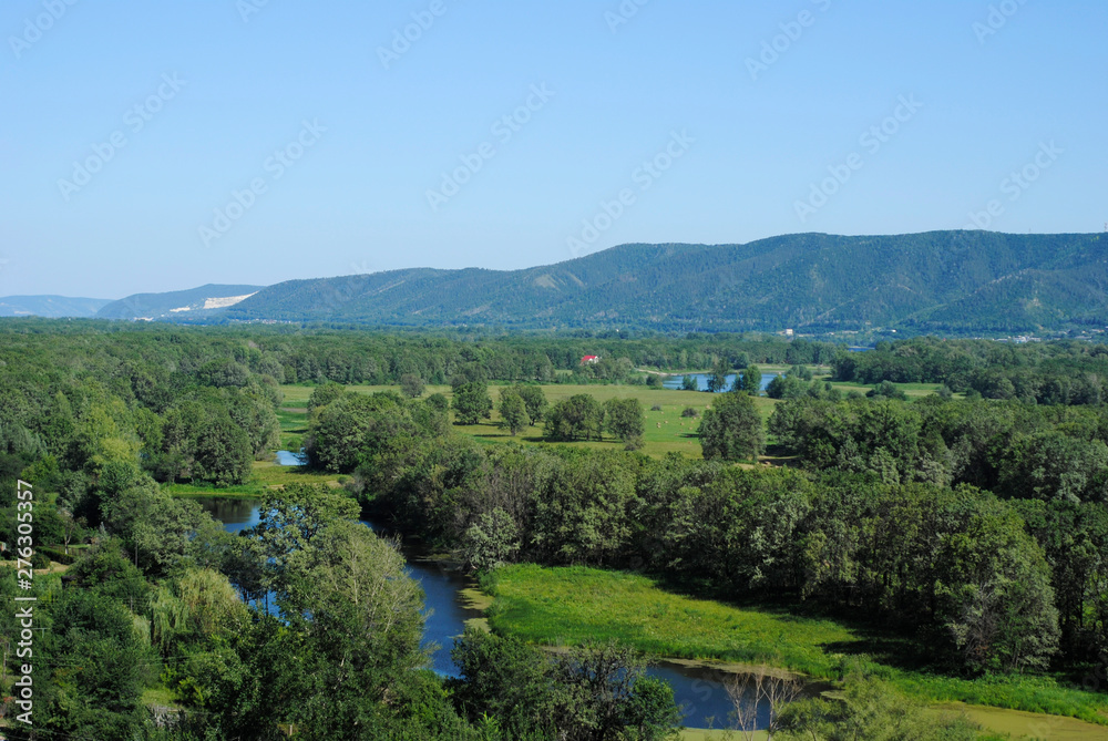 floodplain of the river and mountains on a summer day