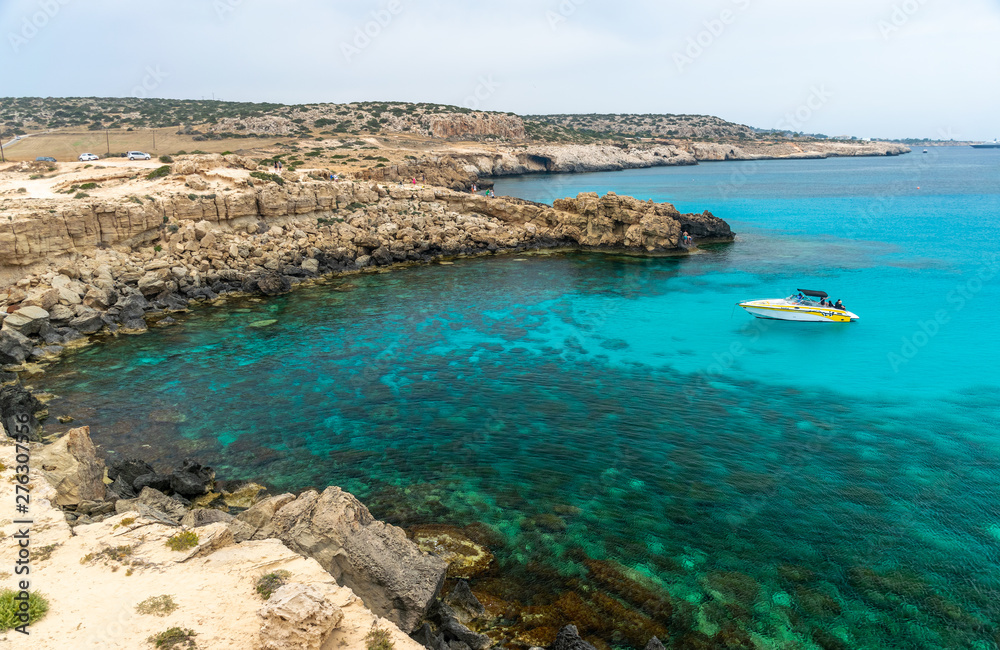 CYPRUS, CAPE CAVO GRECO - MAY 11/2018: Tourists sailed on a motor boat into the blue lagoon for swimming.