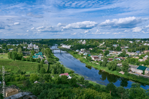 Torzhok, Russia, June 2019.Top view of the summer green city.Visible river, various buildings and above them a blue cloudy sky. © FO_DE