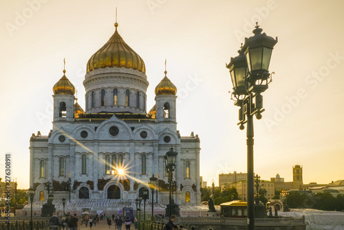 The Cathedral of Christ the Savior, illuminated by the evening sun. The sun's rays penetrate through the building