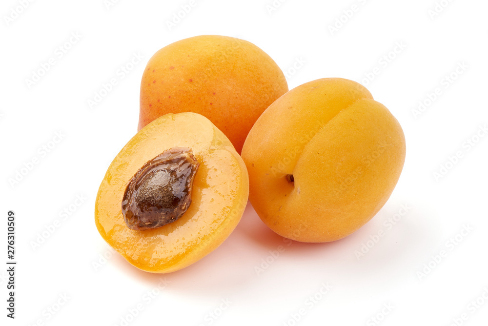 Fresh apricot fruits with juicy half, ripe nectarines, close-up, isolated on white background