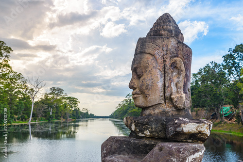 Stone faces in Bayon, Angkor Thom temple, selective focus sunset light. Buddhism meditation concept, world famous travel destination, Cambodia tourism.