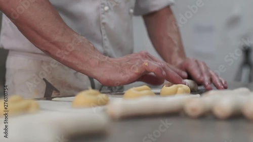 Pastry chef preparing xuixo, a traditional fried bun with cream in catalonia. photo