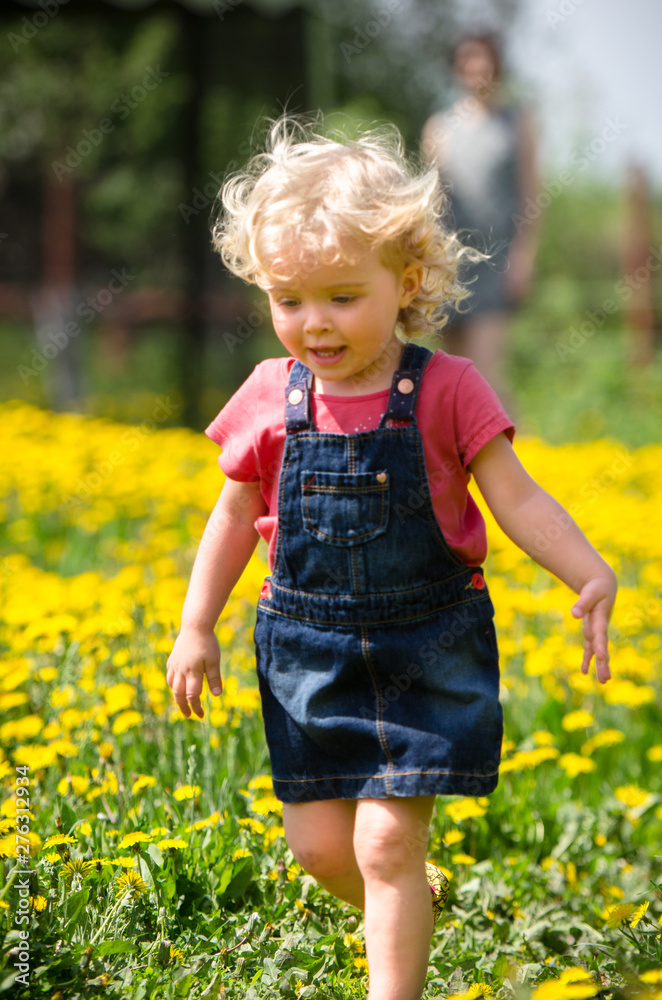 girl walking in a clearing among the flowers girl walking in a clearing among the flowers