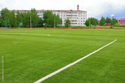 New artificial football field. School stadium in the city. Background.